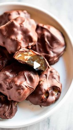 a white plate topped with chocolate covered donuts