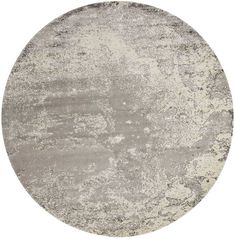 a round rug with grey and white colors