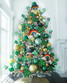 a christmas tree decorated with green and gold ornaments