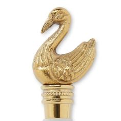 a gold swan bottle stopper on a white background