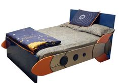 a bed made to look like a space ship with pillows on it's sides