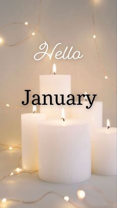 candles with the words hello january written on them in front of a white background filled with lights