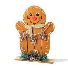 a wooden christmas decoration with gingerbread man