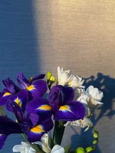 a vase filled with purple and white flowers