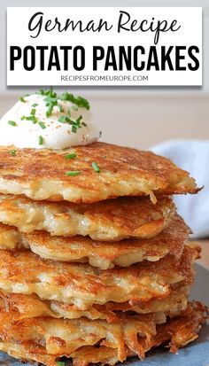 a stack of potato pancakes with sour cream on top