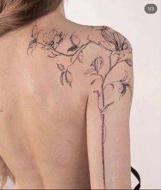 the back of a woman's shoulder with flowers on it