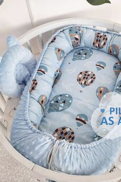 a blue baby crib with a stuffed animal in it's back and the words puli as air written below