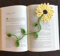 an open book with crocheted flowers on it