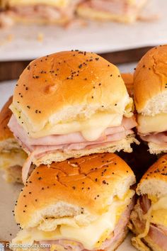 ham and cheese sliders stacked on top of each other with black pepper sprinkles