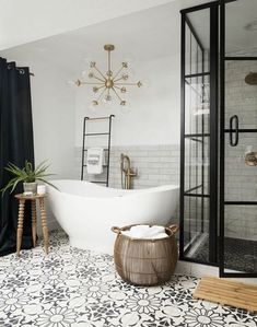 a white bath tub sitting next to a walk in shower