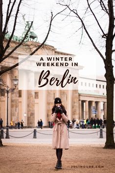 a woman taking a photo in front of a building with text overlay that reads a winter weekend in berlin