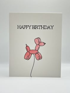 a happy birthday card with a pink balloon dog on it's back and the words, happy birthday