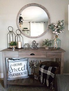 a wooden table topped with pillows and a mirror