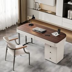 an office desk with a laptop on it in front of a white cabinet and window