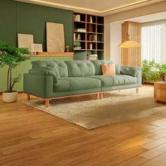 a living room with wood floors and green walls, including a blue couch in the center