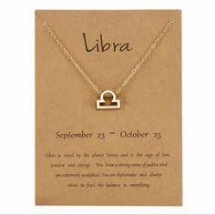 a necklace with the word libra on it and an image of a lock in the middle