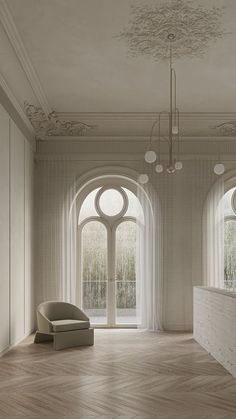 an empty room with large arched windows and wooden flooring on the walls, along with a chair in front of a window