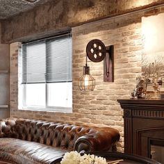 a living room filled with furniture and a fire place in front of a brick wall