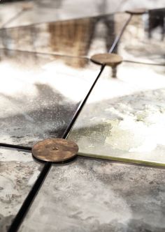 a close up view of the top of a table with two chairs in the background