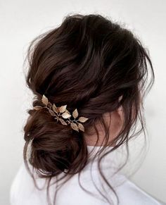 a woman wearing a hair comb with leaves on it