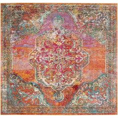 an orange, pink and blue rug with ornate designs on the bottom half of it