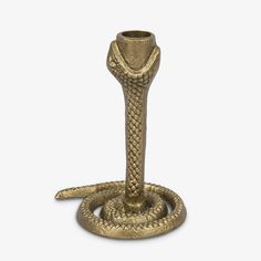 a golden snake - like candle holder on a white background