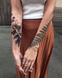 a woman with tattoos on her arm and hand