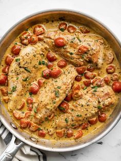 chicken with tomatoes and sauce in a pan