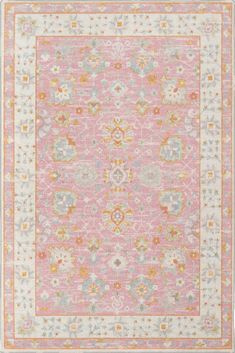 a pink and yellow rug with an ornate design