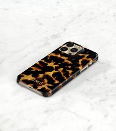 an animal print case for the iphone 11 pro is shown on a marble countertop