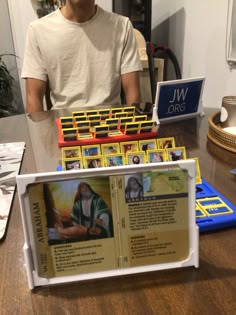 a man standing behind a table filled with cards