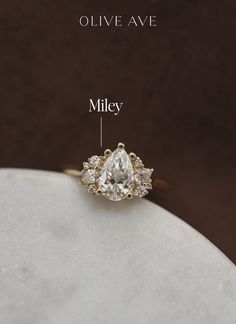 an engagement ring with three pear shaped diamonds on it and the measurements for each stone