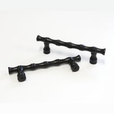 two black metal handles on a white background