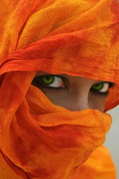 an image of a woman's face covered by a veil with her eyes wide open