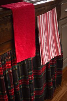 two red and black towels hanging on a rack