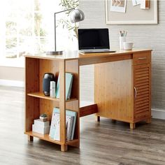 a laptop computer sitting on top of a wooden desk next to a book shelf with books