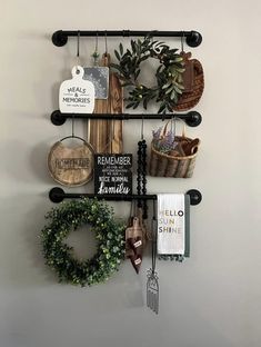 a wall mounted shelf with several items on it and a wreath hanging from the top