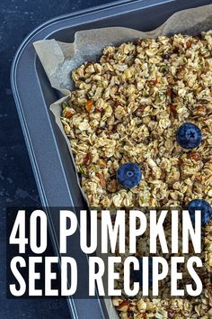 a pan filled with blueberries and granola on top of a black countertop