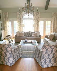 a living room filled with furniture and a chandelier