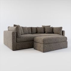 a large sectional couch with pillows on it's back and side facing each other