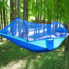 a man laying in a blue hammock