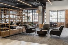 an office with chairs, desks and bookshelves