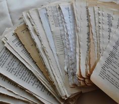 many old books are stacked on top of each other