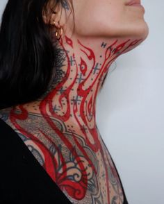 a woman with tattoos on her neck and chest