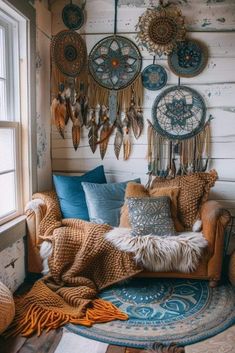 a living room filled with lots of pillows and dream catchers hanging on the wall