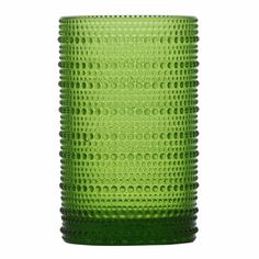 a green glass vase sitting on top of a table