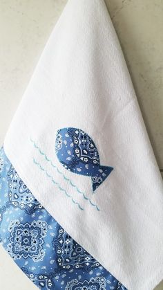 a blue and white towel with a bird on it