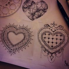 three heart shaped tattoos on top of a piece of paper