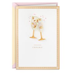 a greeting card with two champagne glasses on the front, and hearts in the background