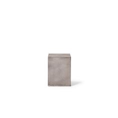 a concrete block sitting on top of a white floor